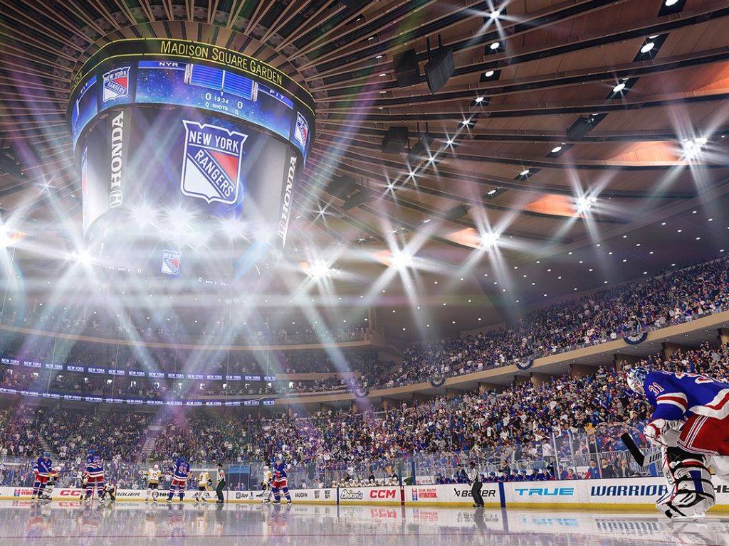 Na obrázku je zobrazená obalová verzia hry NHL 25 pre konzolu PlayStation 5, ktorá zobrazuje dynamiku a vzrušenie z hokejového zápasu. Na prednom pláne je zobrazený detailný pohľad na profesionálnych hokejistov v akcii, s vysoce realistickými animáciami, ktoré zachytávajú intenzitu pohybu a dynamiku zápasu. Hráči na ľade sú v plnej akcii, s výraznými detailmi na ich výstroji, tvárach a v pozadí sa nachádzajú zaplnené tribúny, ktoré dodávajú hračkám intenzívnu atmosféru. Obal hry zároveň zobrazuje logo NHL 25, ktoré naznačuje, že ide o ďalšiu kapitolu populárnej hokejovej série. Na vrchu obalu je značka PlayStation 5, čo signalizuje, že hra je optimalizovaná pre túto platformu, s vylepšenou grafikou a rozšírenými hernými funkciami. Tento obrázok odráža nielen športovú vášeň, ale aj technický pokrok, ktorý NHL 25 prináša hráčom na PS5.